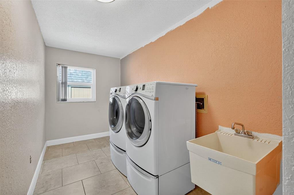 3025 Whitewood Avenue Spring Hill, FL 34609 - Photo 42 of 53 a utility room with dryer and washer