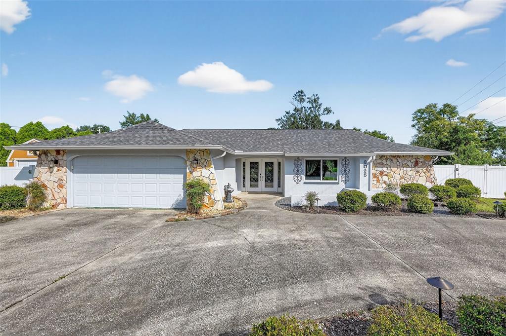 3025 Whitewood Avenue Spring Hill, FL 34609 - Photo 8 of 53 a view of a house with a patio and a yard