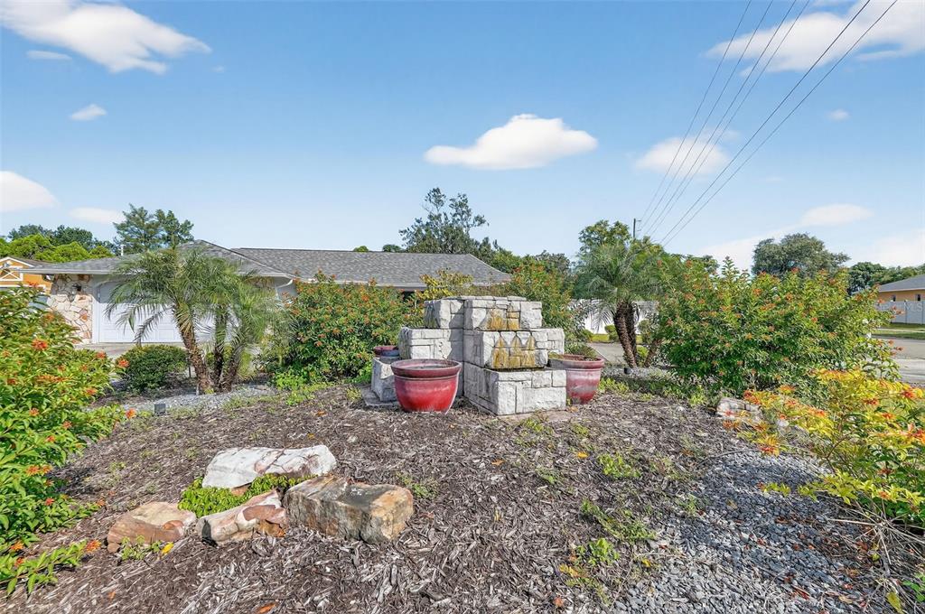 3025 Whitewood Avenue Spring Hill, FL 34609 - Photo 10 of 53 a view of a chairs and table in a backyard