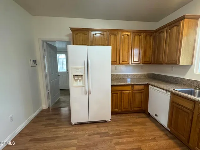 a white refrigerator freezer sitting inside of a kitchen
