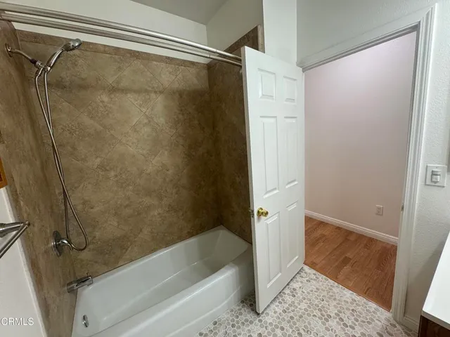 a bathroom with a shower and a tub
