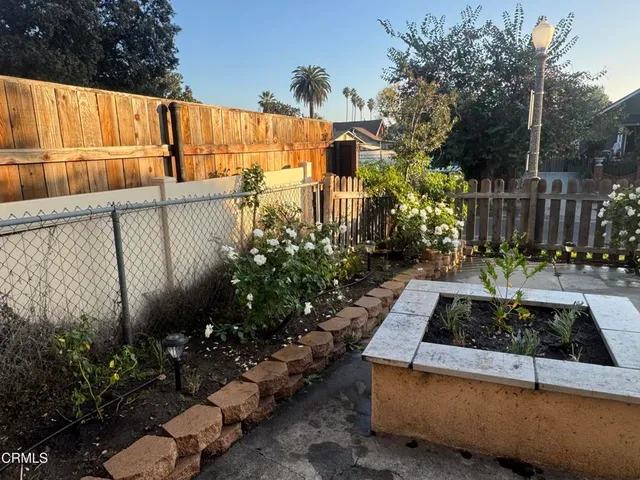 a flower plants with wooden fence