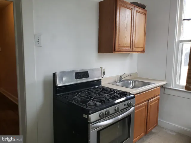 a stove top oven sitting inside of a kitchen