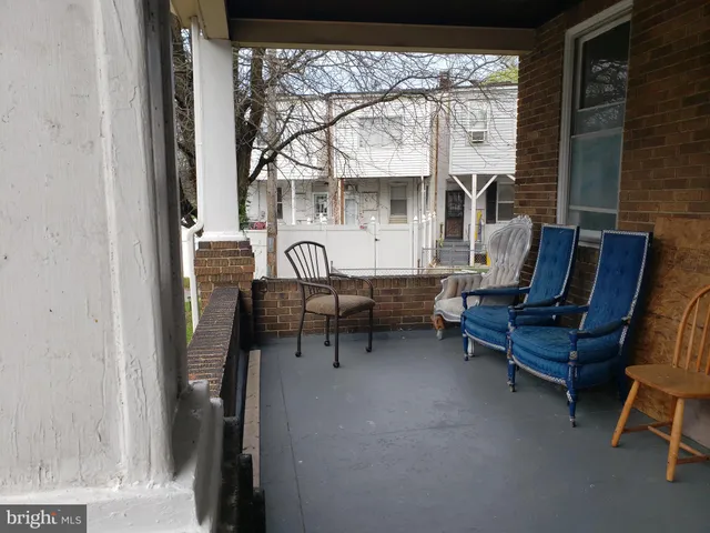 a living room with furniture a fireplace and a floor to ceiling window