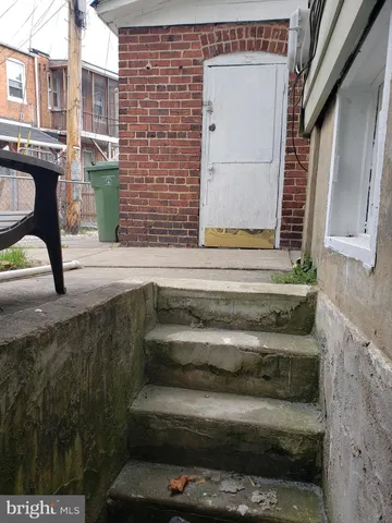 a bathroom with a toilet and a window