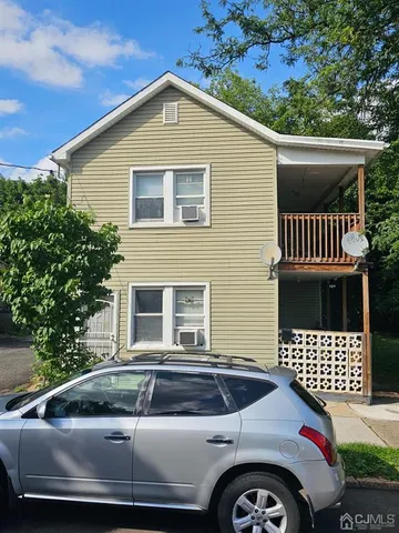 a front view of a house with parking space