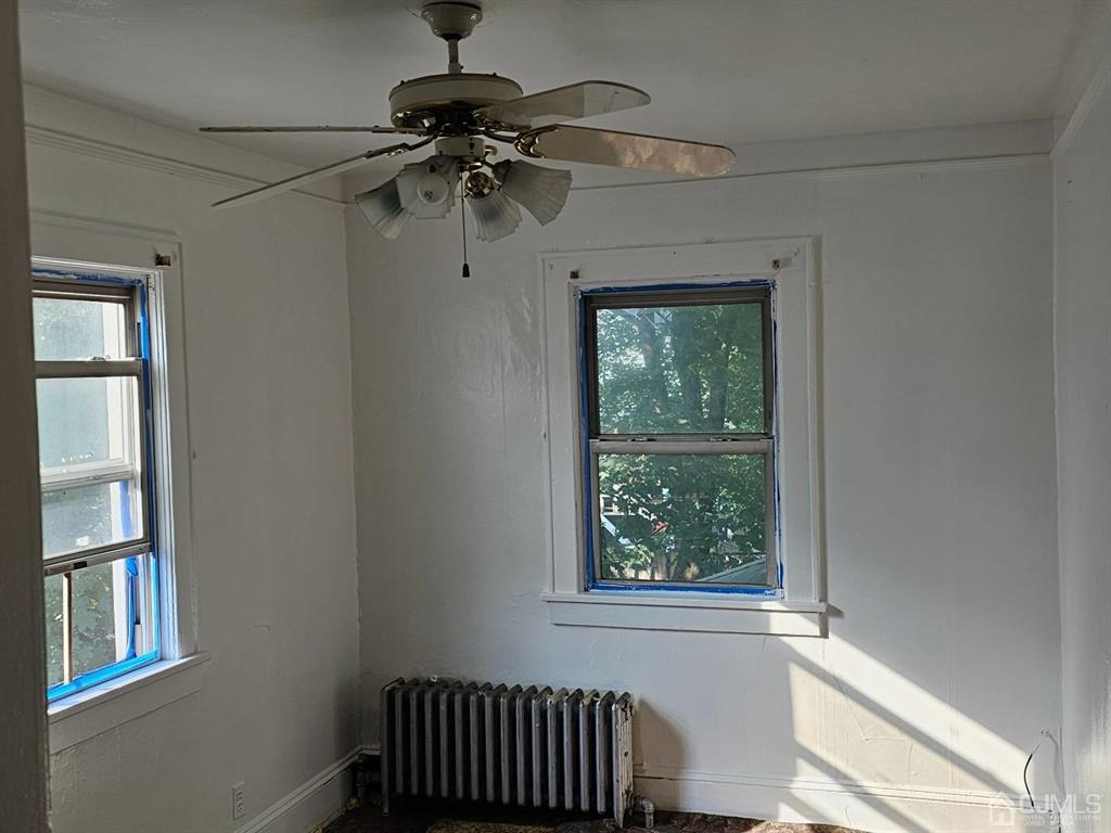 135 Baldwin Street New Brunswick, NJ 08901 - Photo 4 of 8 a view of hallway with windows and chandelier