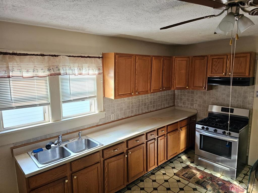 135 Baldwin Street New Brunswick, NJ 08901 - Photo 6 of 8 a kitchen with stainless steel appliances a sink stove and cabinets