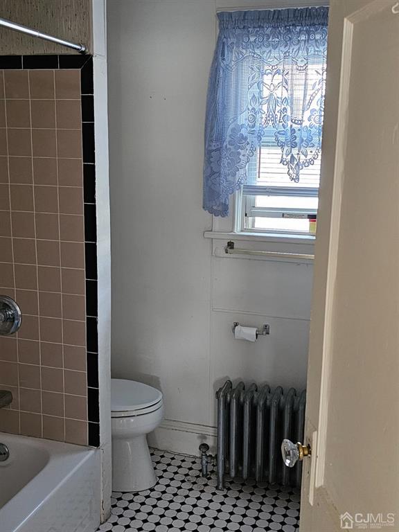 135 Baldwin Street New Brunswick, NJ 08901 - Photo 8 of 8 a bathroom with a toilet a window and shower