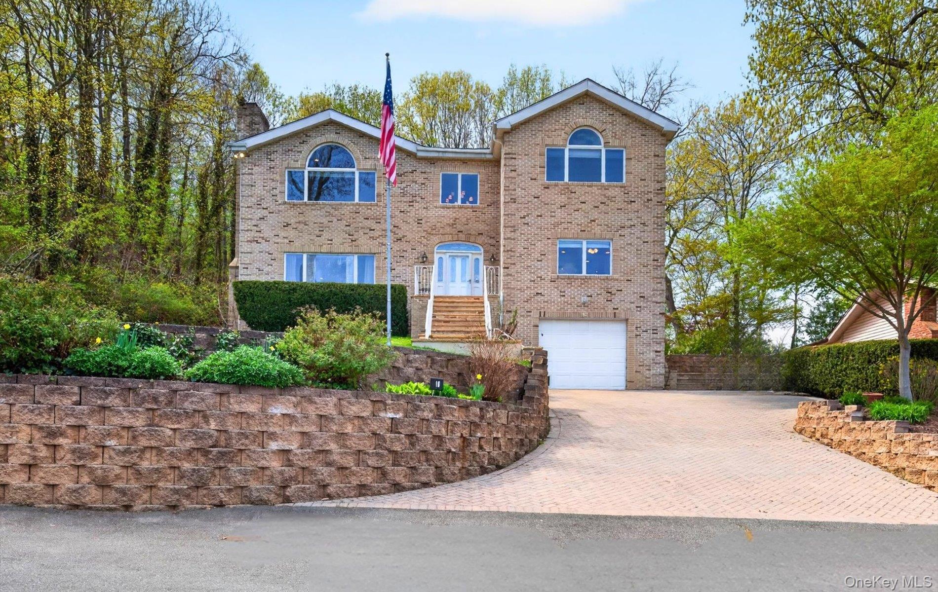 Brick exterior residence featuring multiple windows and an arched window.
