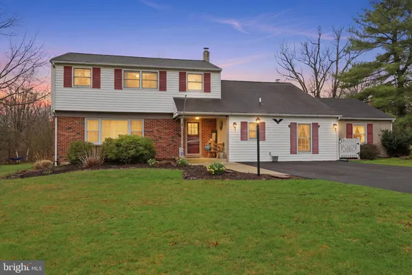 a front view of a house with outdoor seating