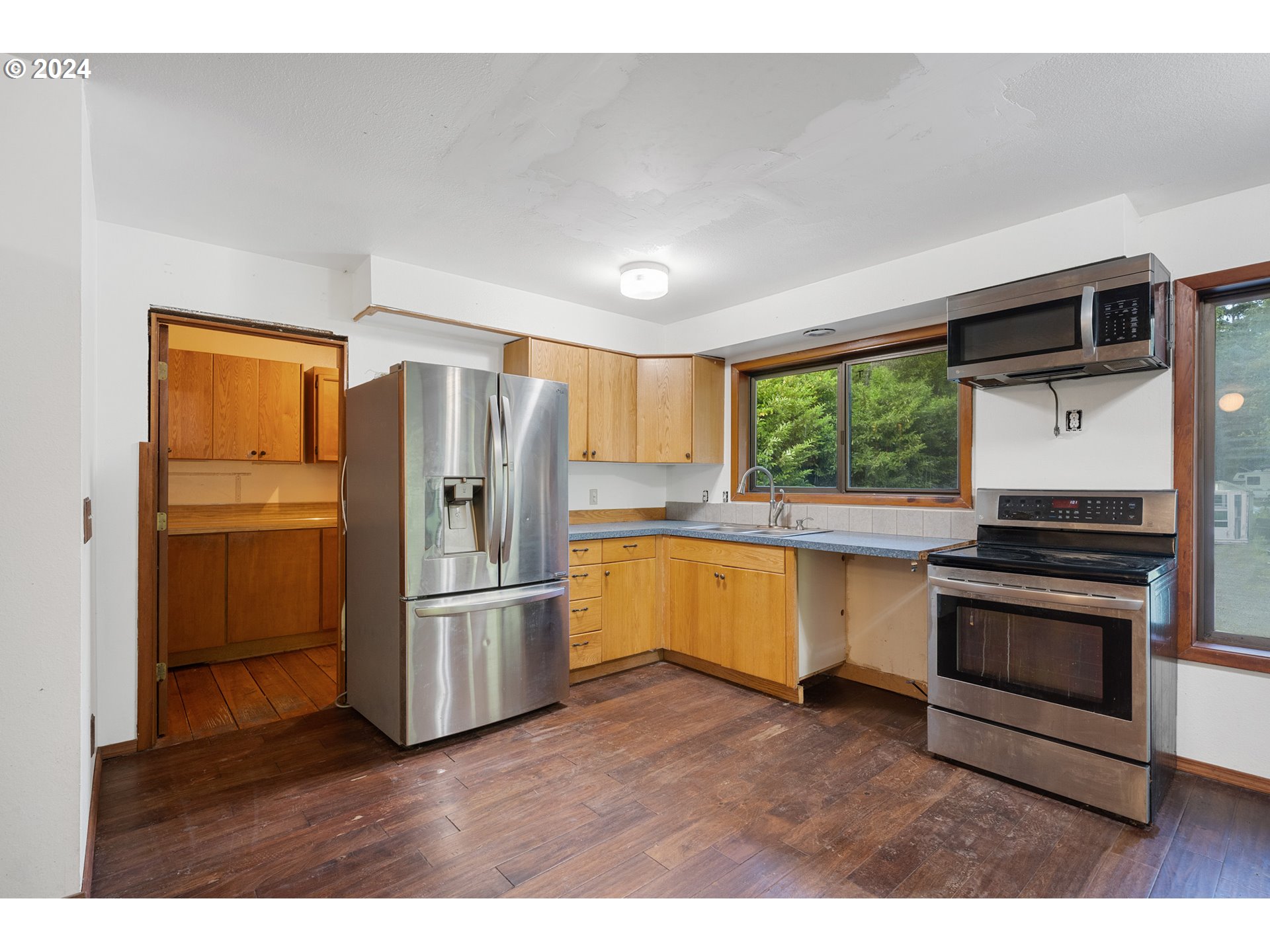 15555 Trask River Road Tillamook, OR 97141 - Photo 11 of 30 a kitchen with stainless steel appliances granite countertop a refrigerator a sink and a stove