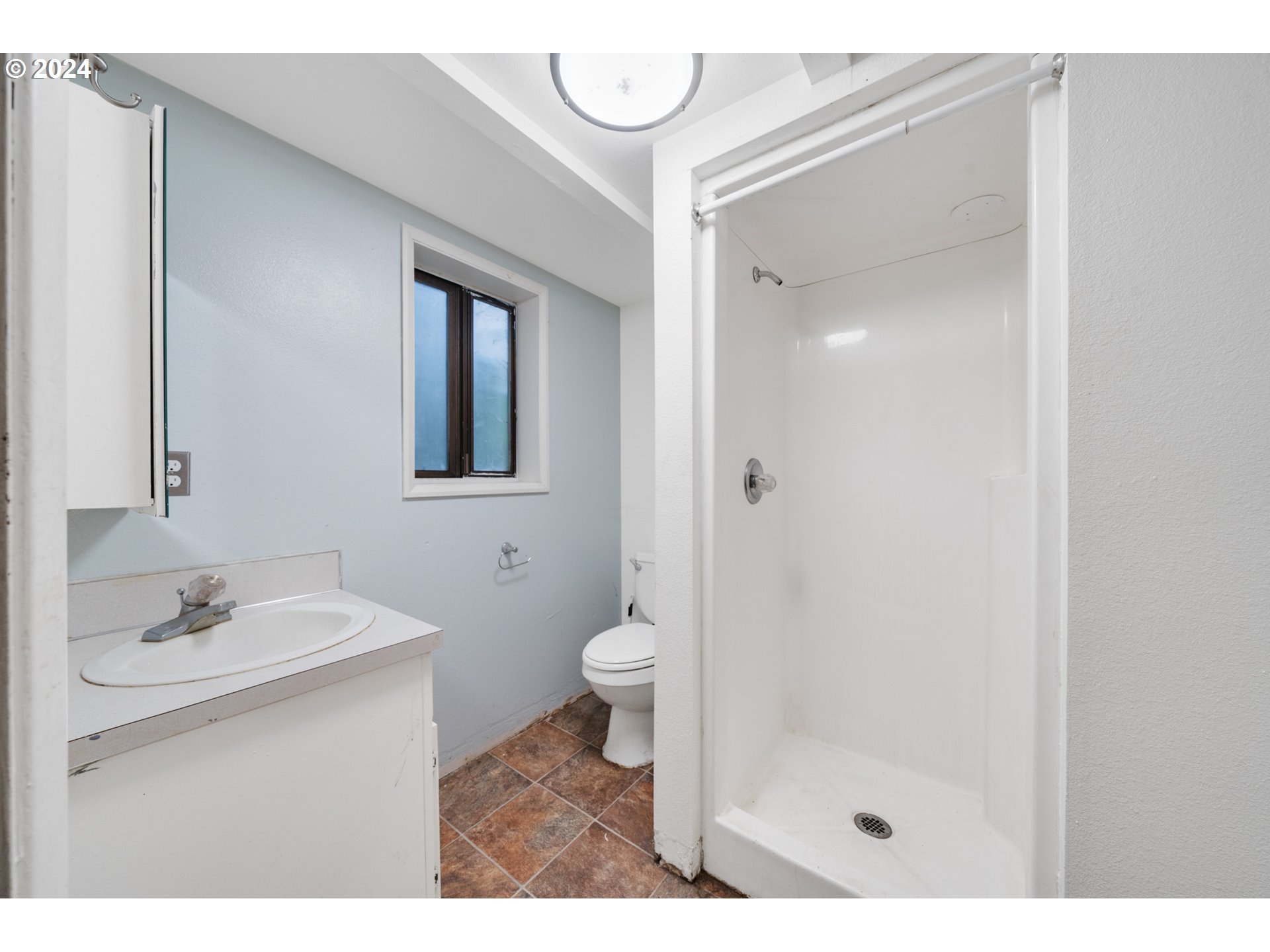 15555 Trask River Road Tillamook, OR 97141 - Photo 27 of 30 a bathroom with a sink a toilet and a mirror