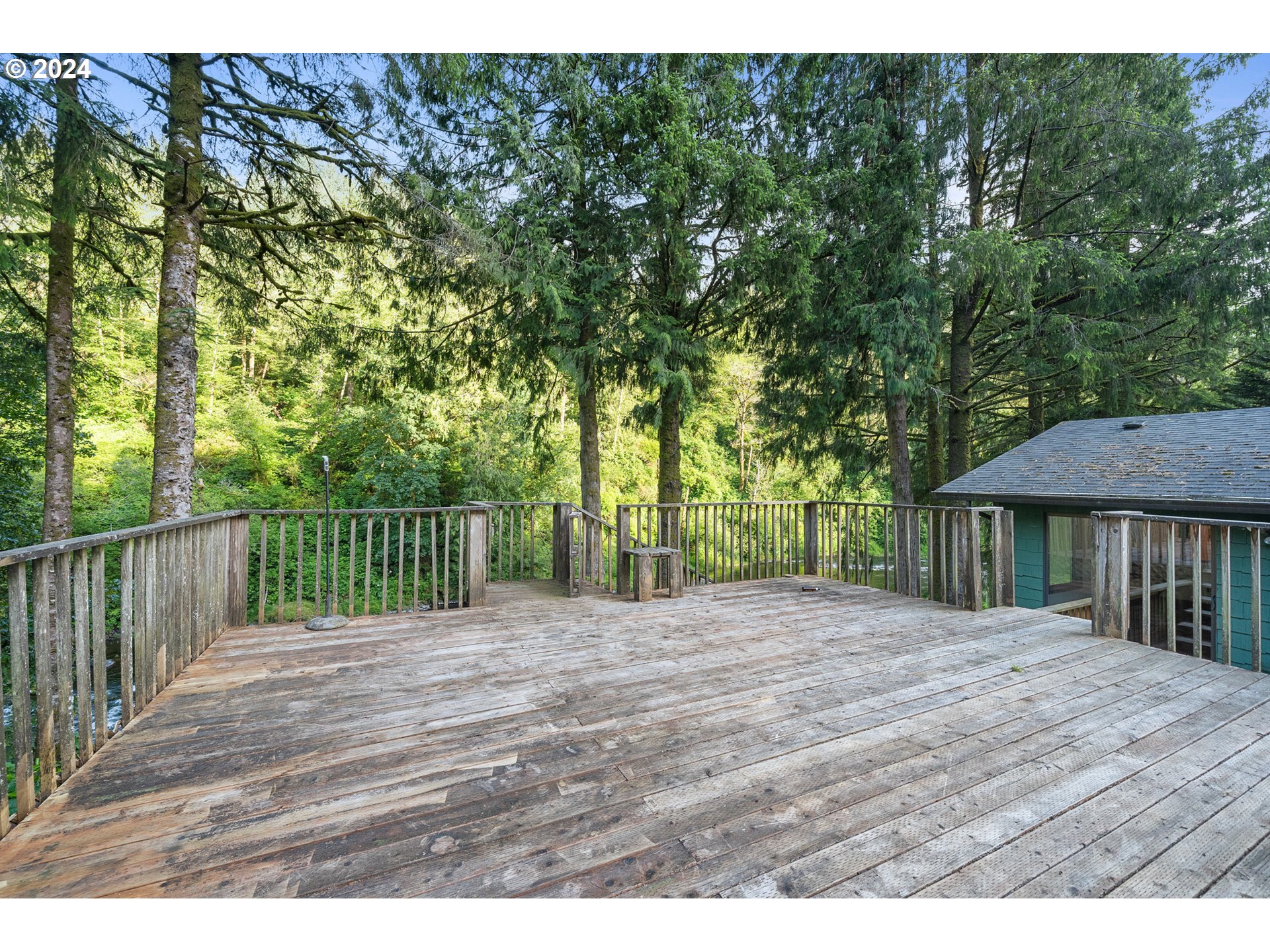15555 Trask River Road Tillamook, OR 97141 - Photo 6 of 30 a view of backyard with a deck and wooden fence