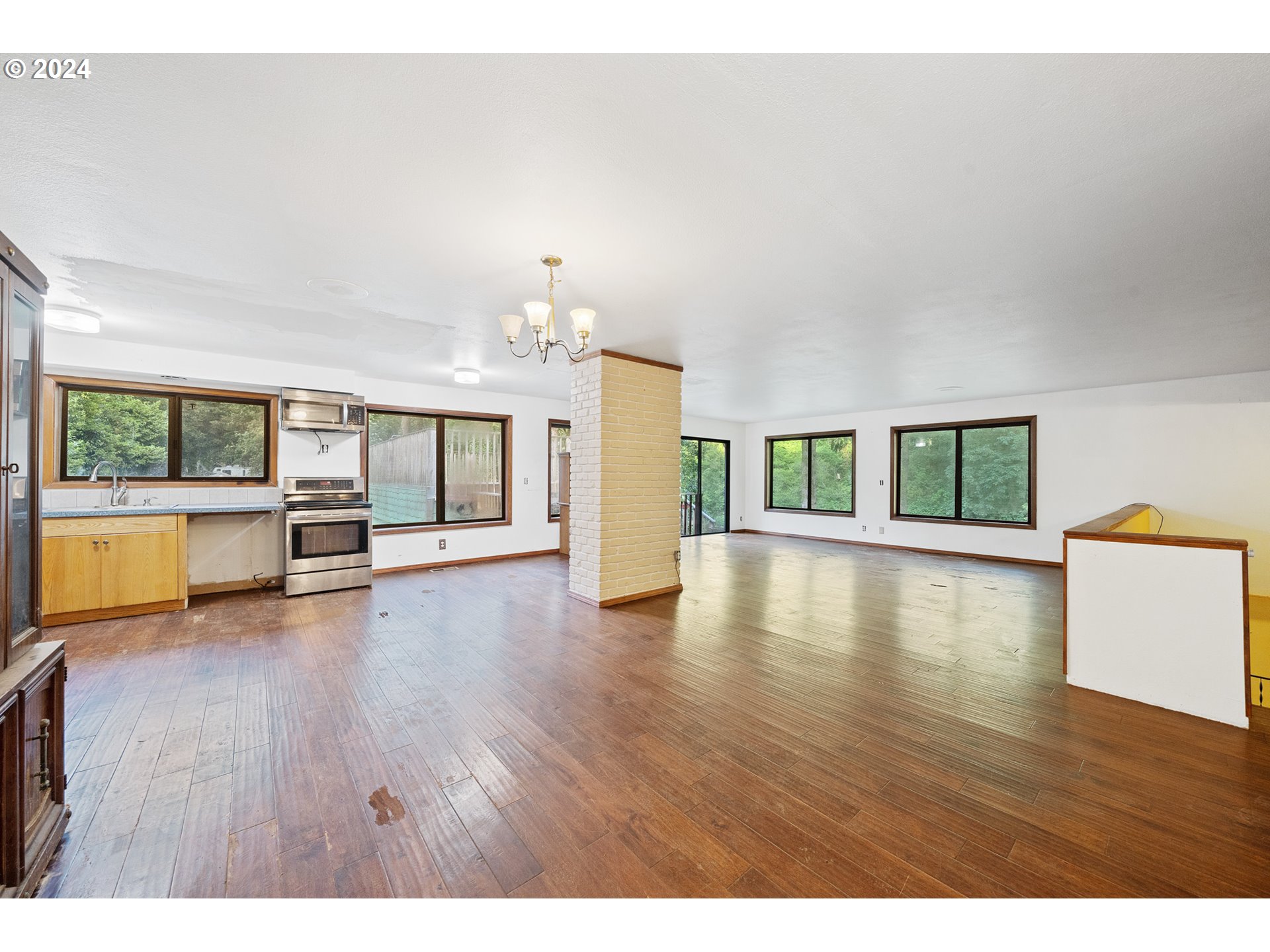 15555 Trask River Road Tillamook, OR 97141 - Photo 7 of 30 a view of an empty room with wooden floor and a window