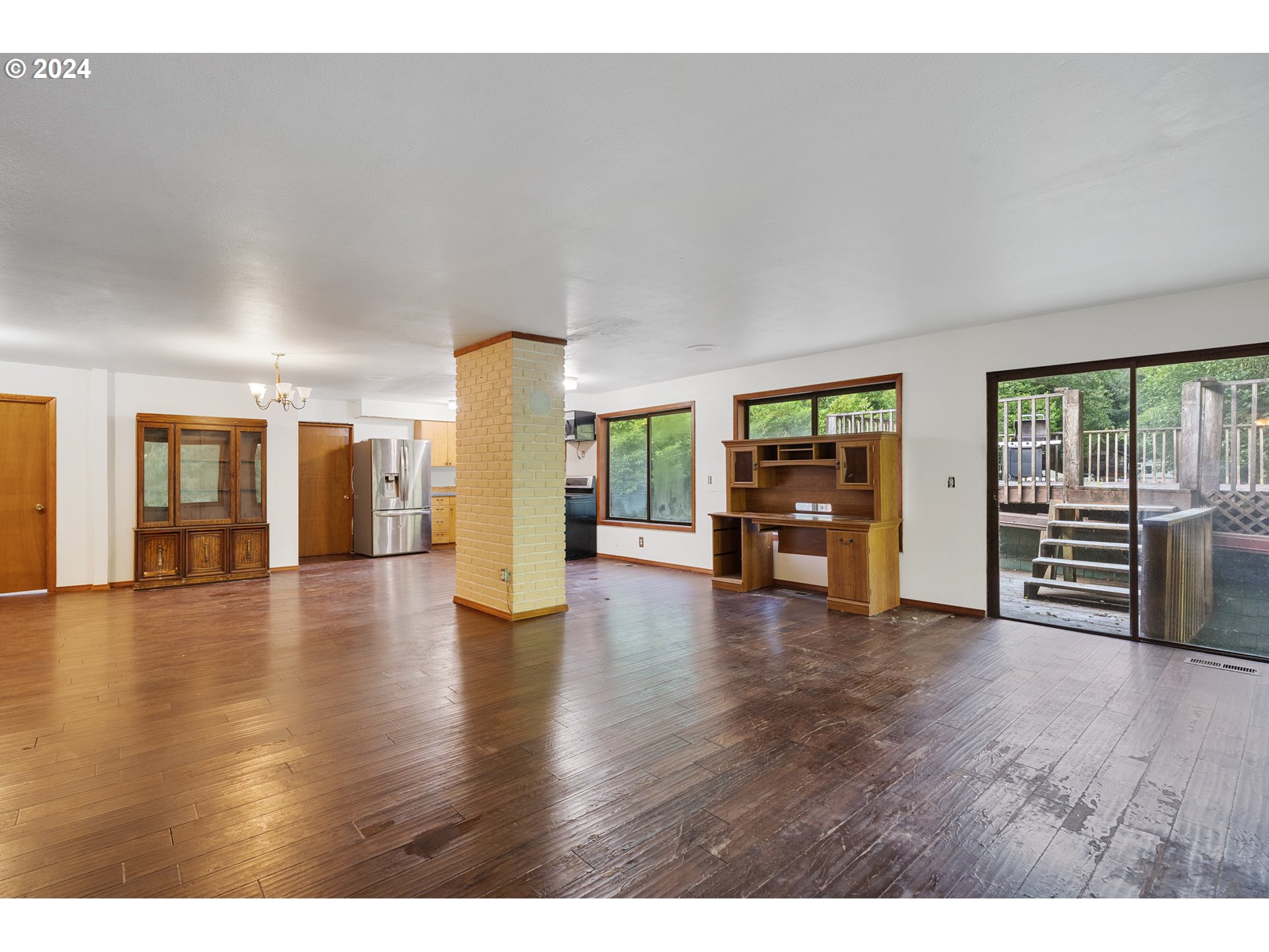15555 Trask River Road Tillamook, OR 97141 - Photo 8 of 30 a view of an empty room with wooden floor and windows