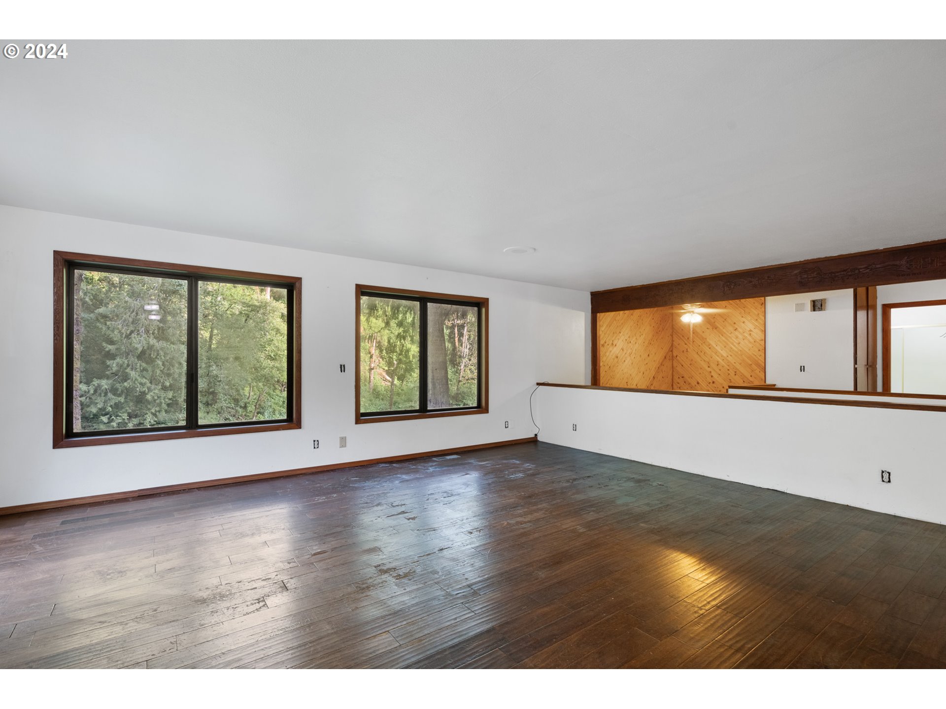 15555 Trask River Road Tillamook, OR 97141 - Photo 9 of 30 a view of an empty room with wooden floor and windows