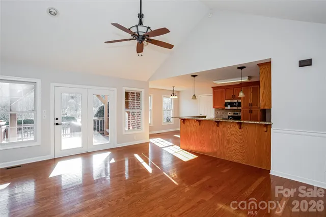 a view of a living room a window and wooden floor