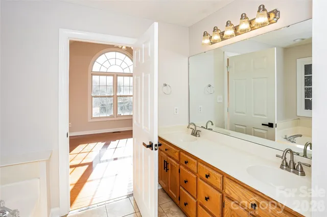 a spacious bathroom with double vanity and a mirror