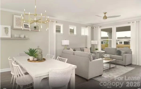 a living room with furniture white walls and kitchen view