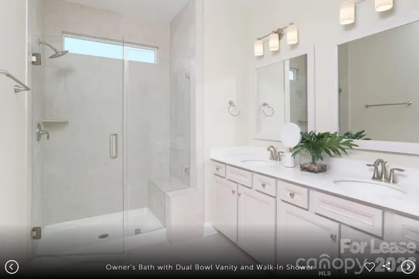 a bathroom with a shower sink and mirror