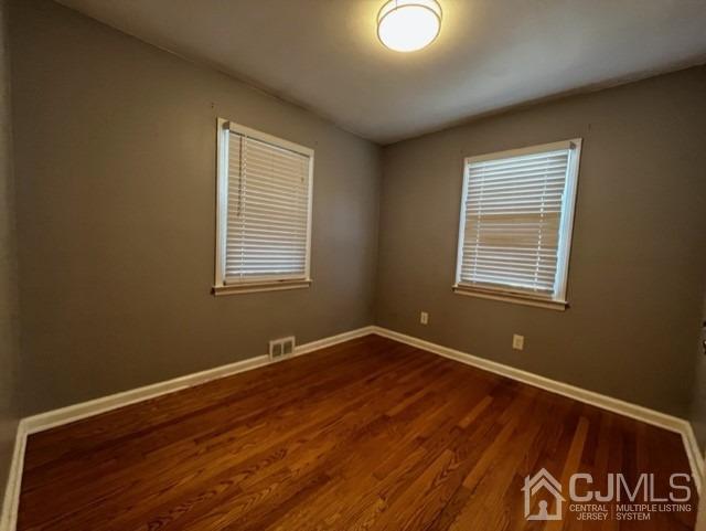 89 Leo Street Edison, NJ 08817 - Photo 11 of 31 a view of an empty room with wooden floor and a window