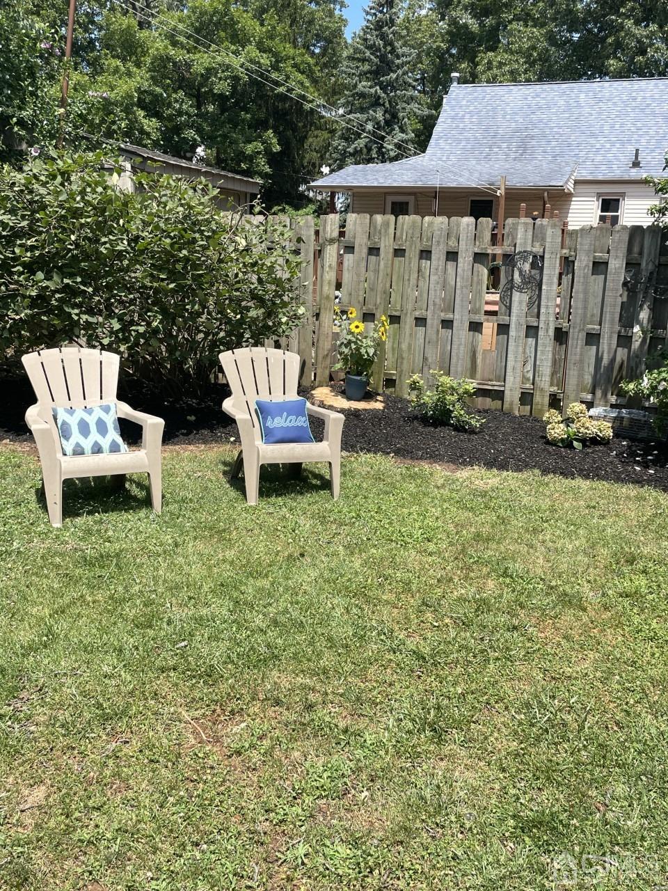 89 Leo Street Edison, NJ 08817 - Photo 26 of 31 a view of a patio with table and chairs potted plants and a large tree