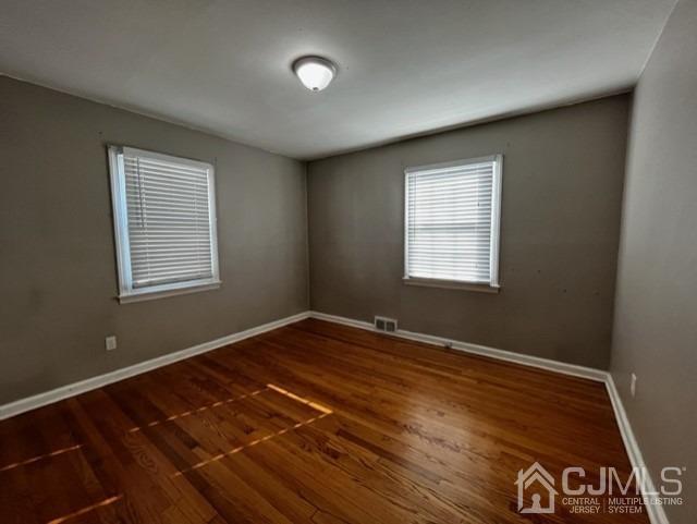89 Leo Street Edison, NJ 08817 - Photo 10 of 31 a view of an empty room with wooden floor and a window