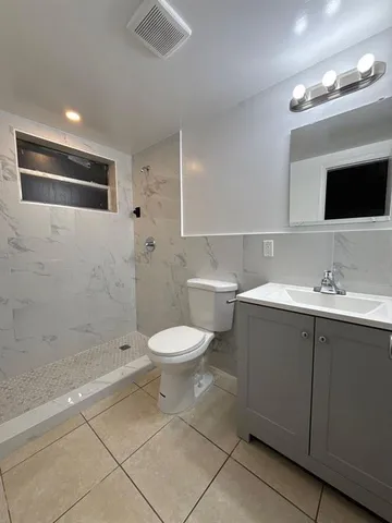 a bathroom with a toilet sink and shower