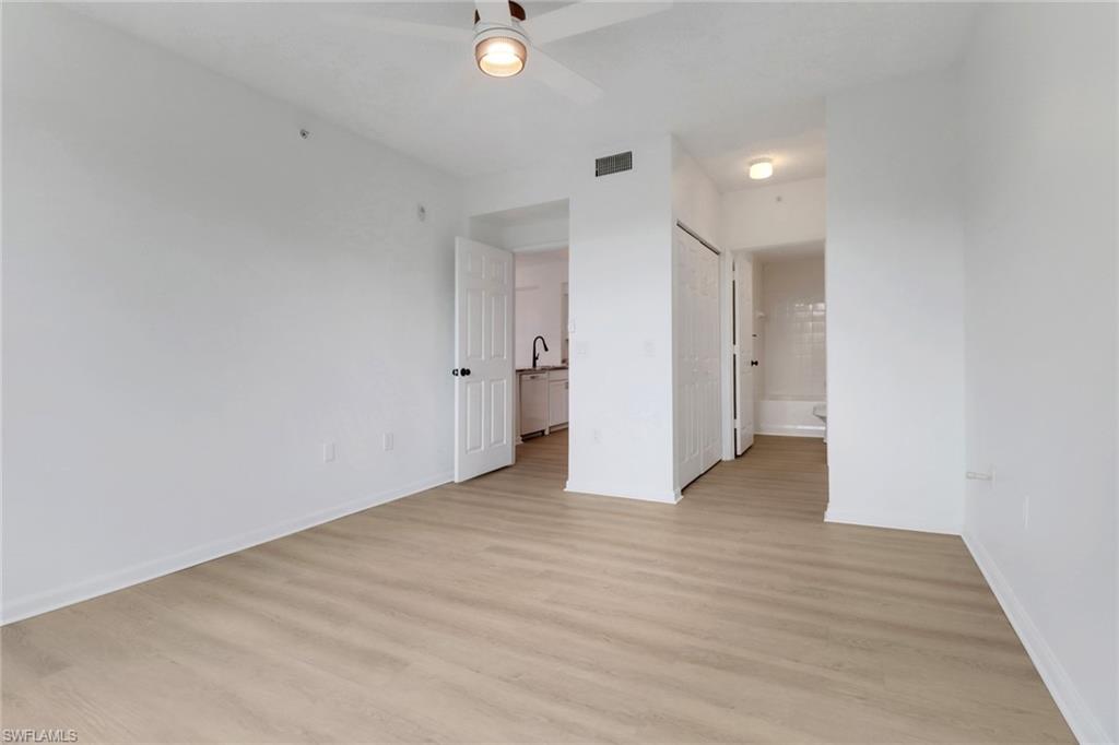 1190 Reserve Way, Unit 206 Naples, FL 34105 - Photo 13 of 35 a view of an empty room with wooden floor