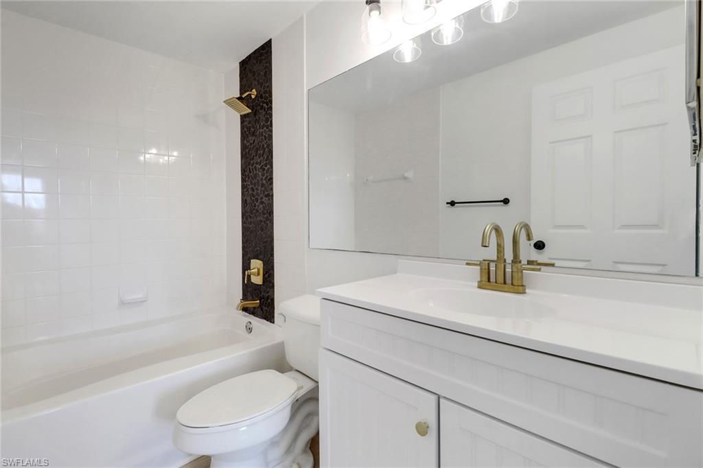 1190 Reserve Way, Unit 206 Naples, FL 34105 - Photo 14 of 35 a bathroom with a sink a toilet and shower