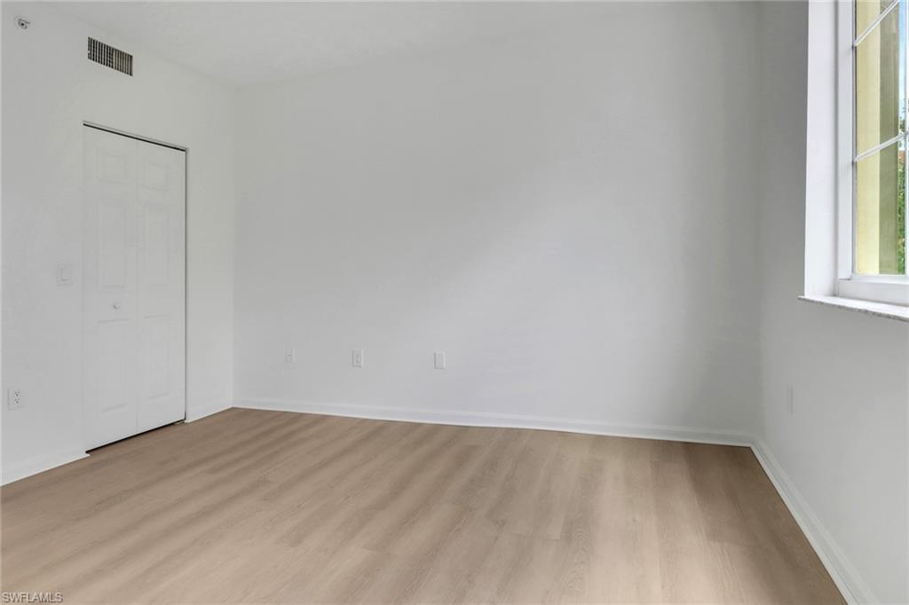 1190 Reserve Way, Unit 206 Naples, FL 34105 - Photo 17 of 35 an empty room with a window