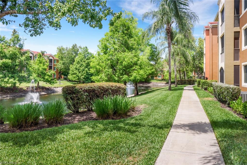 1190 Reserve Way, Unit 206 Naples, FL 34105 - Photo 26 of 35 a view of a garden with plants and a lake view