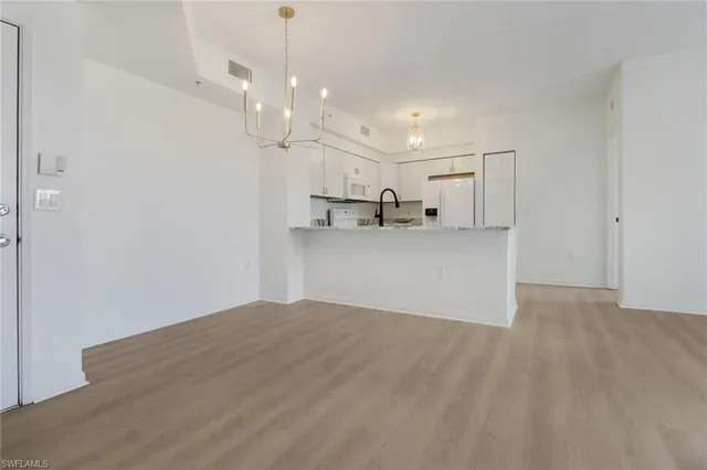 a view of a kitchen with a sink and a refrigerator