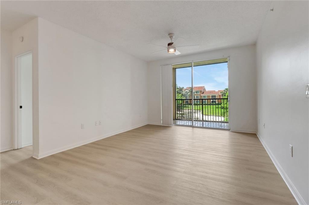 1190 Reserve Way, Unit 206 Naples, FL 34105 - Photo 9 of 35 wooden floor in an empty room with a window