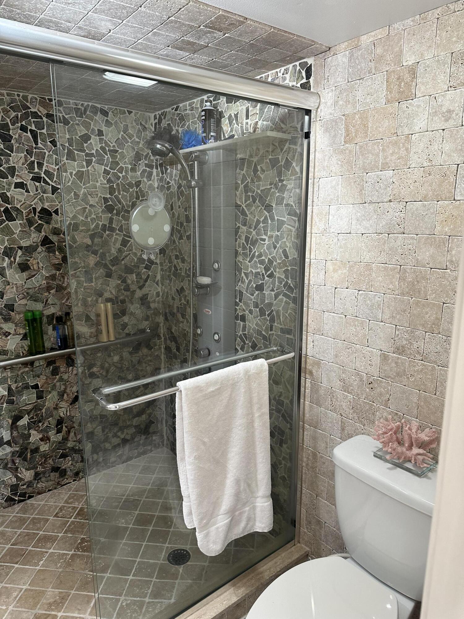 7370 South Ocean Drive, Unit 215 Jensen Beach, FL 34957 - Photo 18 of 51 a bathroom with a toilet and a shower