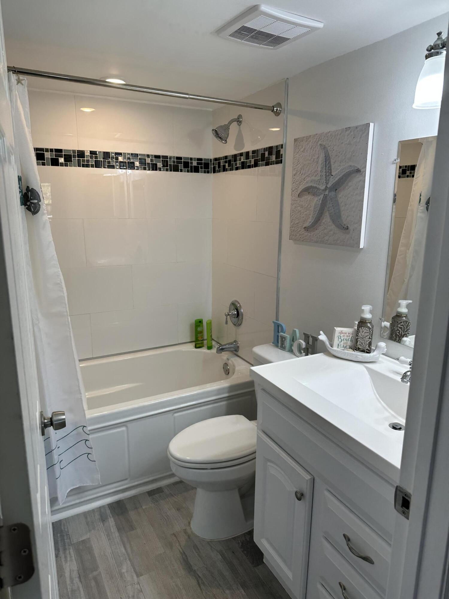 7370 South Ocean Drive, Unit 215 Jensen Beach, FL 34957 - Photo 20 of 51 a bathroom with a granite countertop sink mirror vanity and toilet