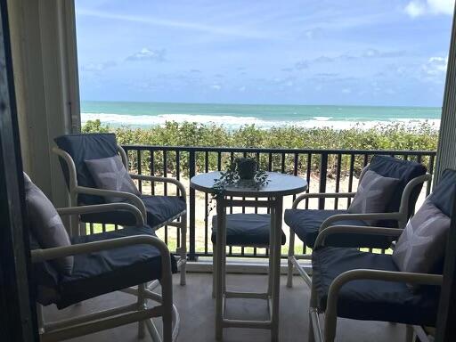 7370 South Ocean Drive, Unit 215 Jensen Beach, FL 34957 - Photo 21 of 51 a view of a chairs and table in the balcony