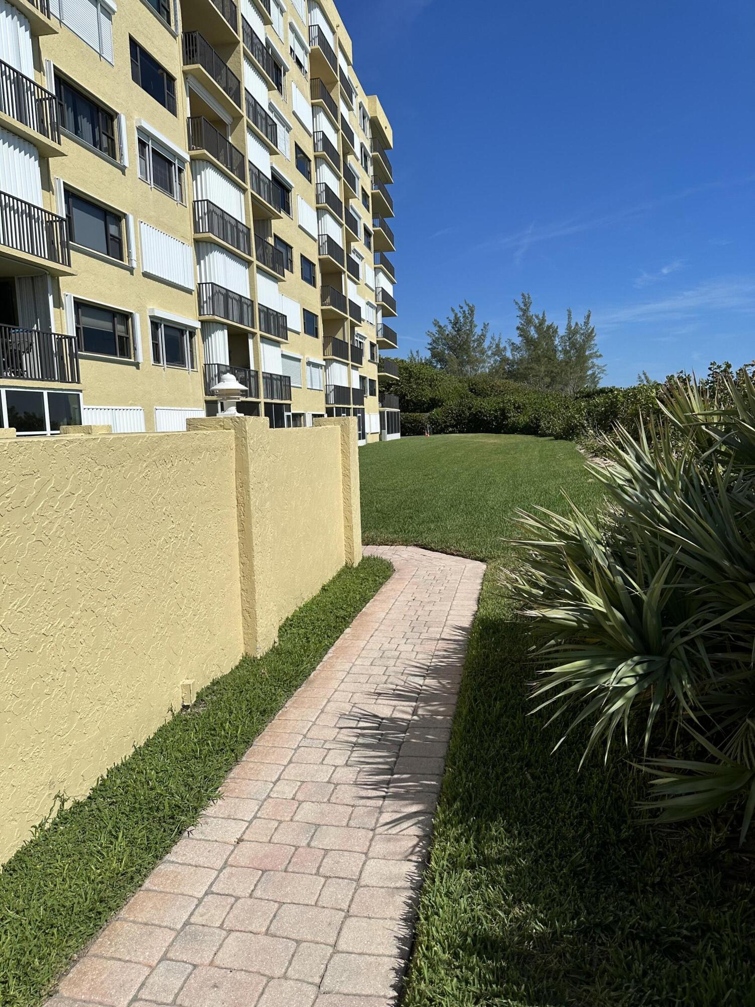 7370 South Ocean Drive, Unit 215 Jensen Beach, FL 34957 - Photo 27 of 51 a view of building with garden
