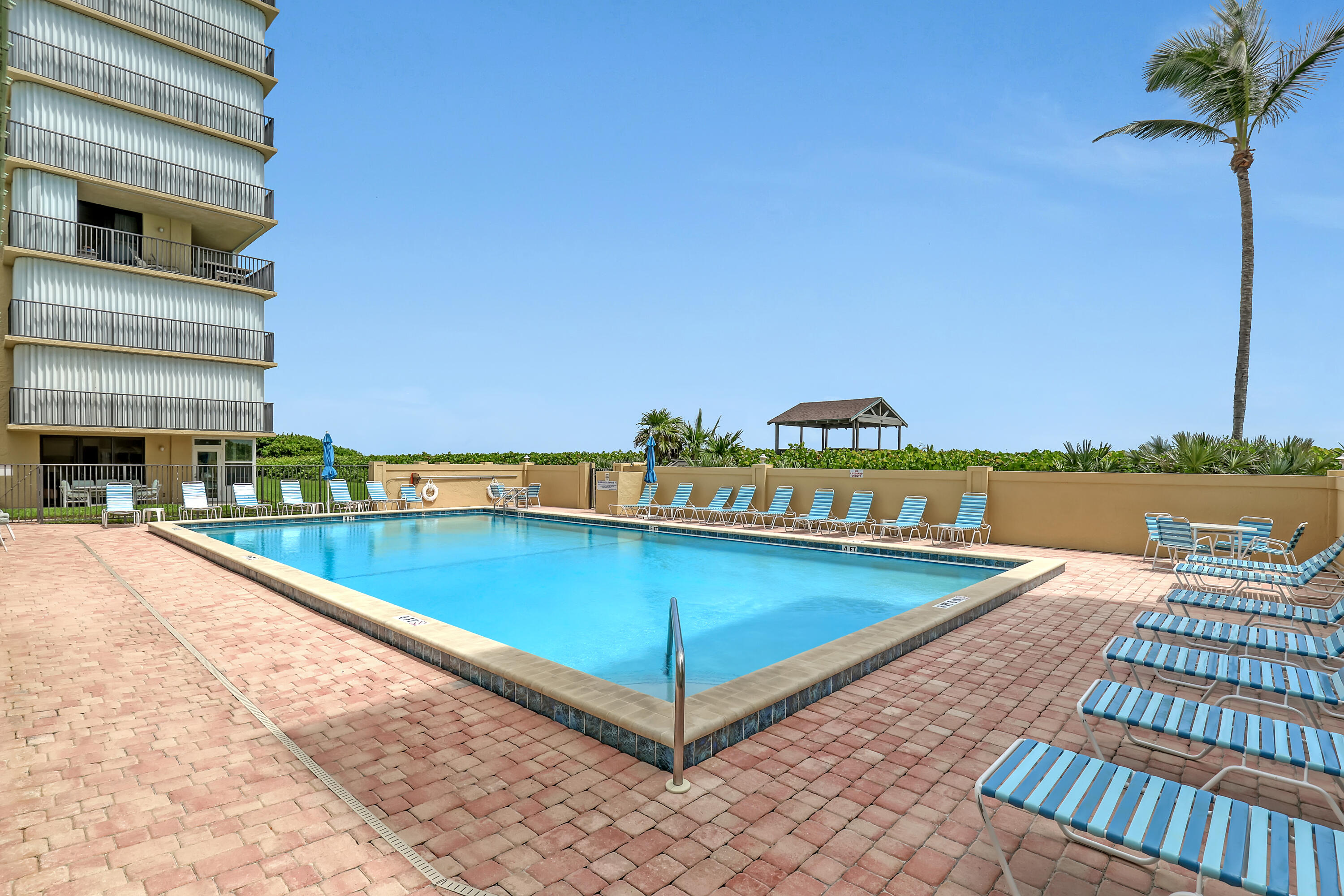 7370 South Ocean Drive, Unit 215 Jensen Beach, FL 34957 - Photo 38 of 51 a view of a swimming pool with lounge chair