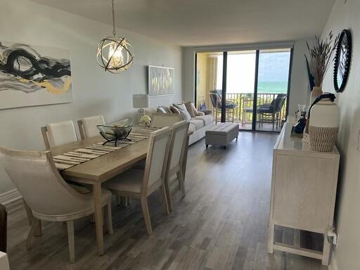 7370 South Ocean Drive, Unit 215 Jensen Beach, FL 34957 - Photo 9 of 51 a view of a dining room with furniture window and wooden floor