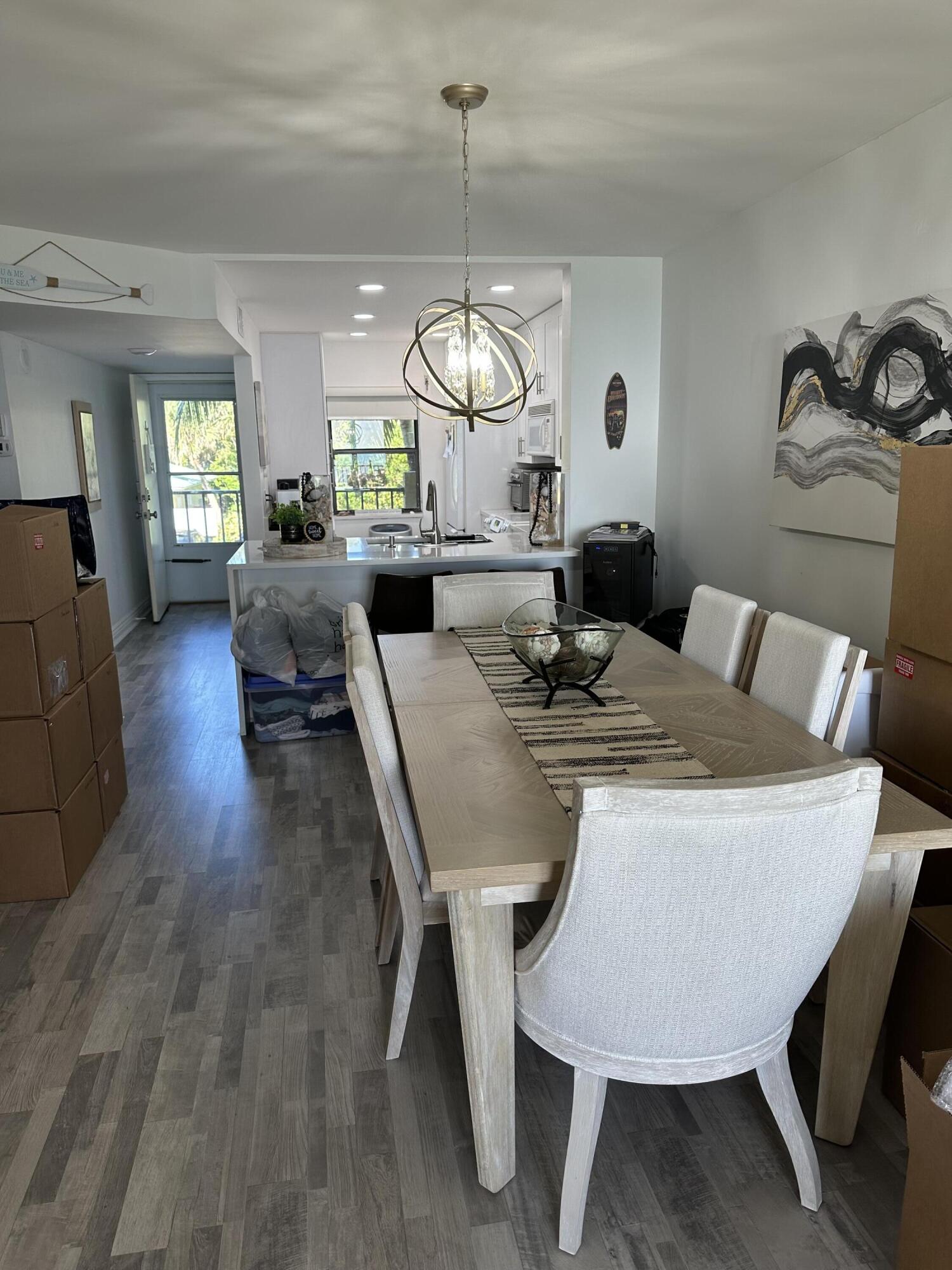 7370 South Ocean Drive, Unit 215 Jensen Beach, FL 34957 - Photo 10 of 51 a view of a dining room with furniture window and wooden floor