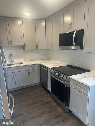 a kitchen with a sink stove and microwave