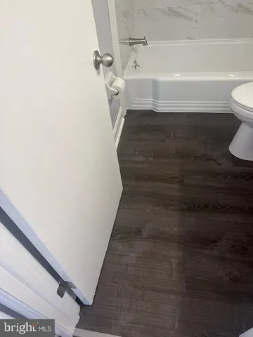 a bathroom with a toilet and a bathtub