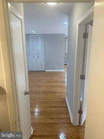 a view of hallway with wooden floor