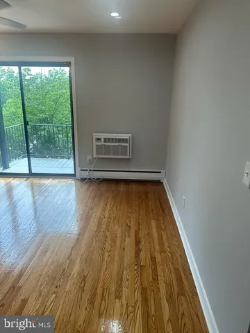 a view of room with wooden floor and window