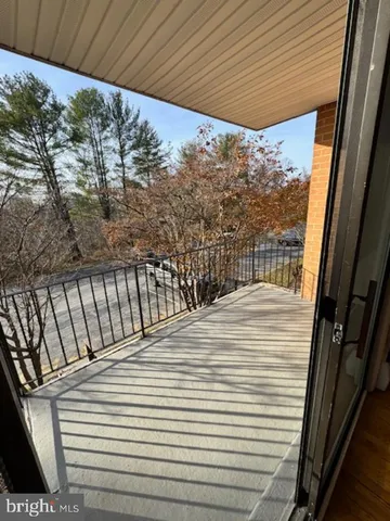 a view of a balcony with wooden floor