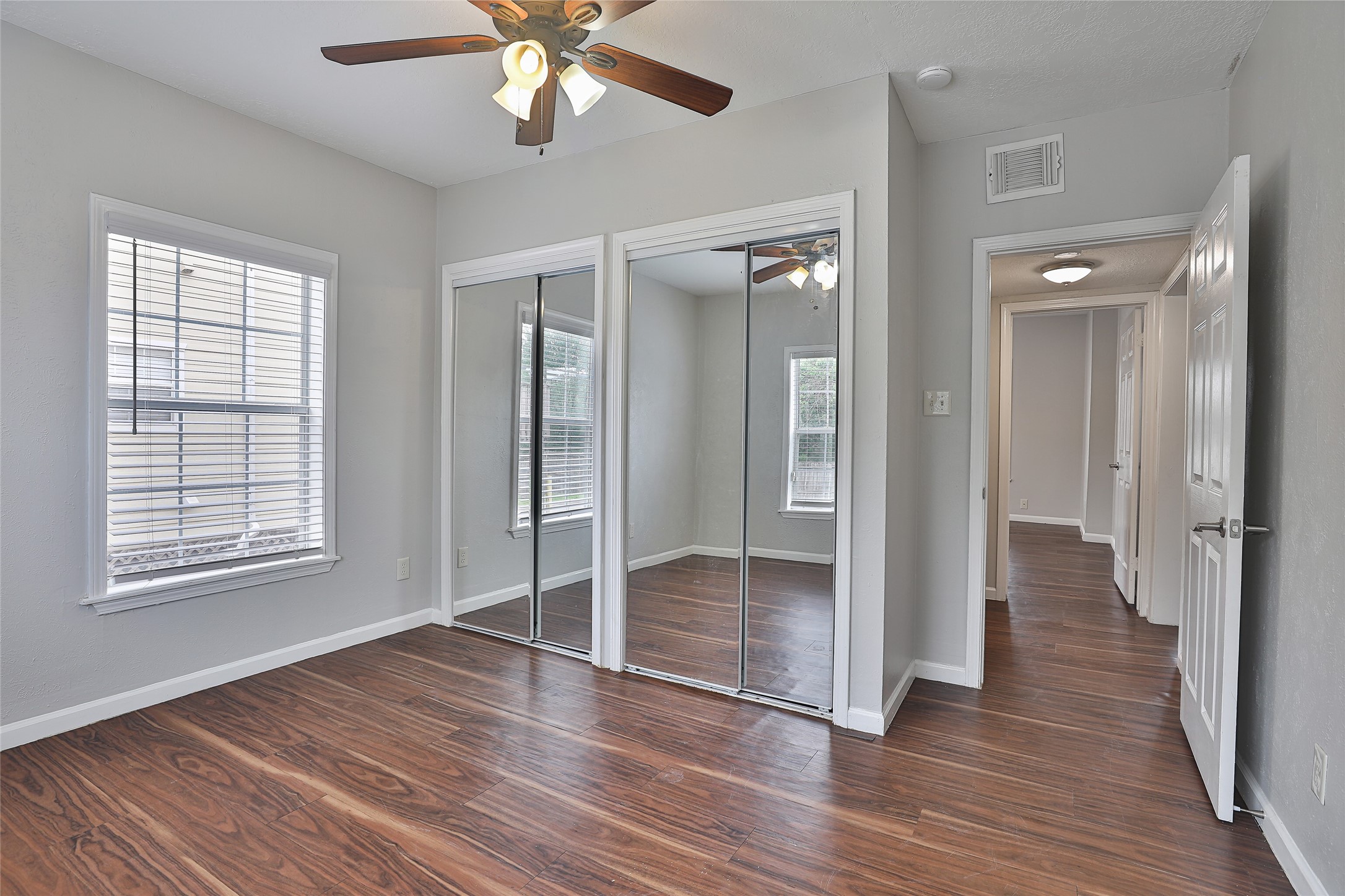 5009 Polk Street Houston, TX 77023 - Photo 11 of 16 a view of empty room with wooden floor and fan