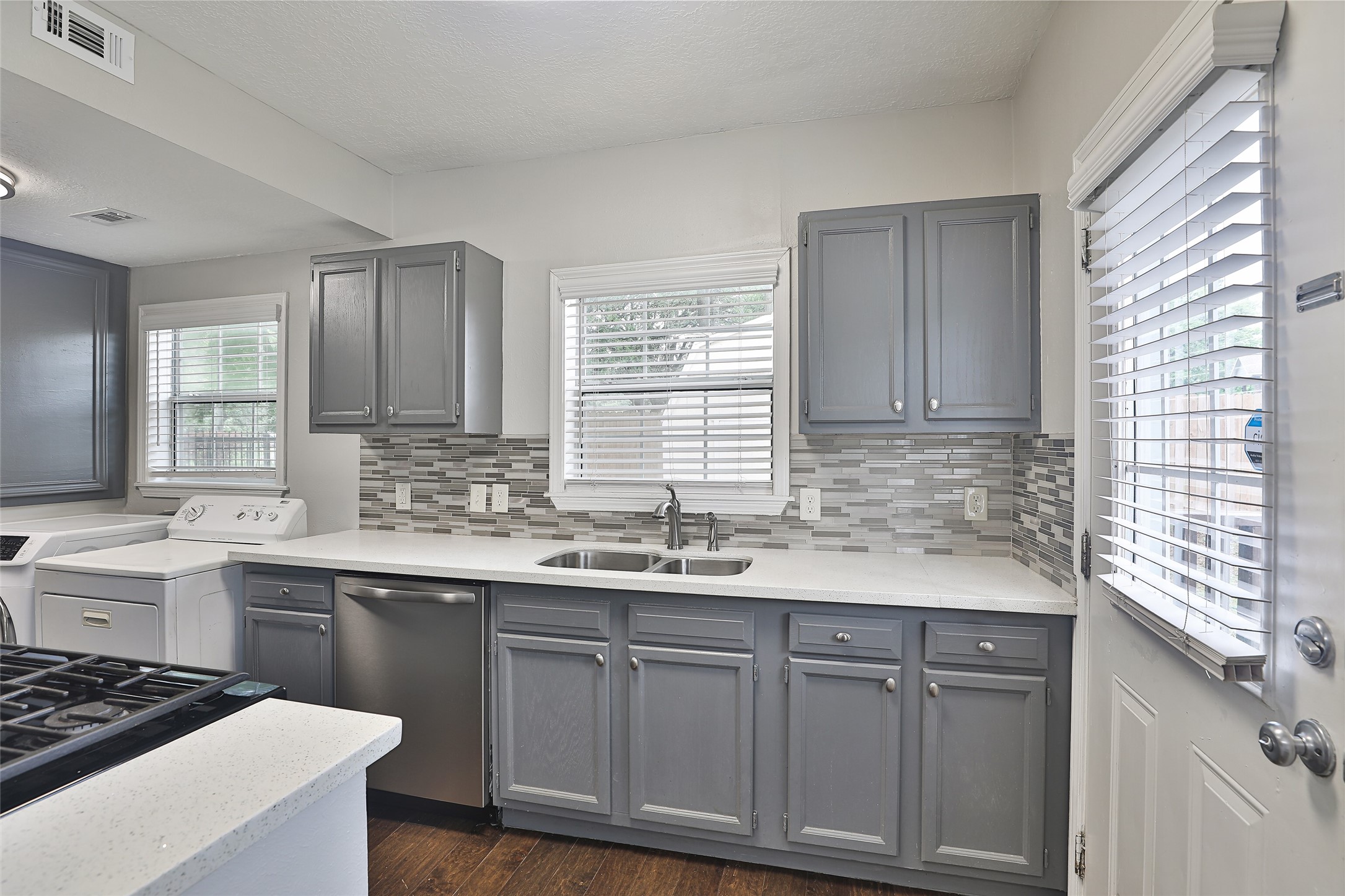 5009 Polk Street Houston, TX 77023 - Photo 12 of 16 a kitchen with a sink stove and cabinets