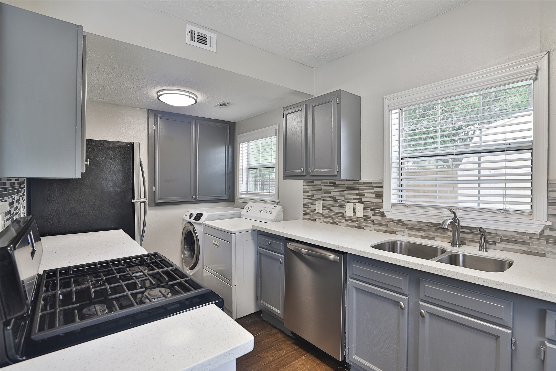 5009 Polk Street Houston, TX 77023 - Photo 13 of 16 a kitchen with a sink stove and cabinets
